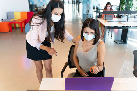 Business women works in the office with social distance because of pandemic