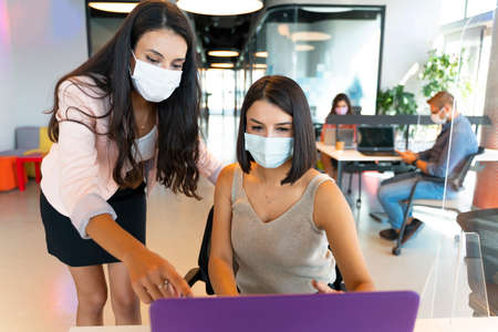 Business women works in the office with social distance because of pandemicの写真素材