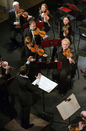 DNIPROPETROVSK, UKRAINE - FEBRUARY 9: Members of the Symphonic Orchestra - main conductor Natalia Ponomarchuk perform at the State Russian Drama Theatre on Feb. 9, 2015 in Dnipropetrovsk, Ukraineのeditorial素材