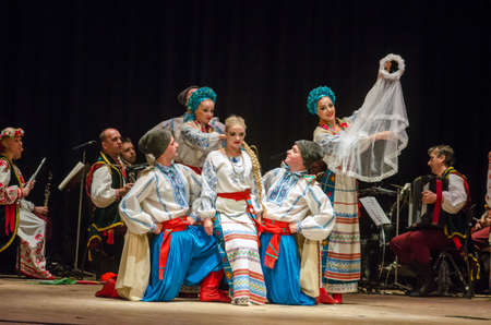 DNIPRO, UKRAINE - NOVEMBER 7, 2018: National traditions, customs and rites of the Ukrainian people performed by members of the Folklore Ensemble SLAVUTYCH  at the  State Drama  Theatre.のeditorial素材