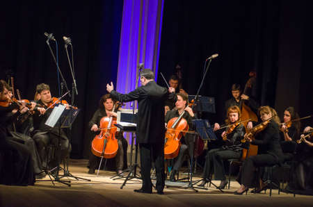 DNIPRO, UKRAINE â MARCH 4, 2019: FOUR SEASONS Chamber Orchestra - main conductor Dmitry Logvin perform at the State Drama Theatre.のeditorial素材