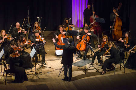 DNIPRO, UKRAINE â MARCH 4, 2019: FOUR SEASONS Chamber Orchestra - main conductor Dmitry Logvin perform at the State Drama Theatre.のeditorial素材