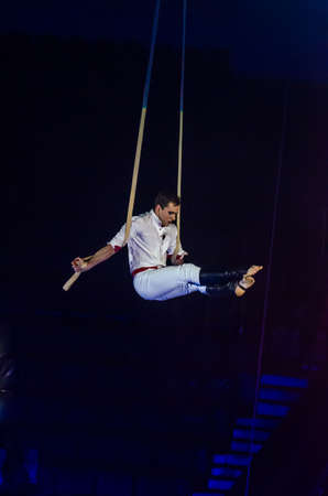 DNIPRO, UKRAINE - DECEMBER 14, 2018: Gymnast on the belts Yuri Kravchenko performs at the Circus.のeditorial素材