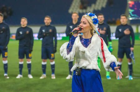 DNIPRO, UKRAINE - NOVEMBER 23, 2019: Singer Yulia Tsyupilo performs the anthem of Ukraine before the match of the Premier League SC Dnipro-1 against FC Vorskla.のeditorial素材