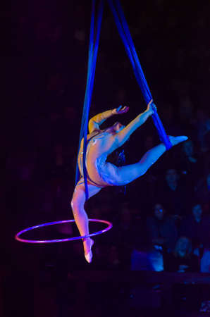 DNIPRO, UKRAINE - DECEMBER 13, 2019:  Aerial gymnast on cor de volan with hula hoop Ponomarenko Sofia performs at the Circus.のeditorial素材