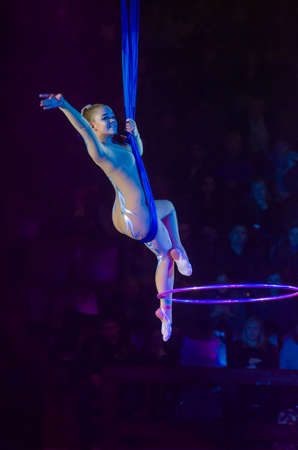 DNIPRO, UKRAINE - DECEMBER 13, 2019:  Aerial gymnast on cor de volan with hula hoop Ponomarenko Sofia performs at the Circus.のeditorial素材