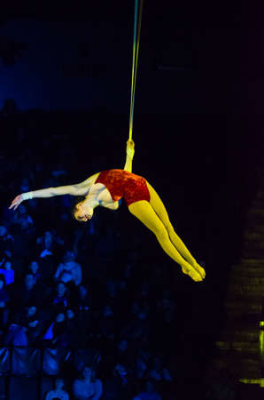 DNIPRO, UKRAINE - DECEMBER 14, 2019: Air gymnast on the belts Elena Baina performs at the Circus.のeditorial素材
