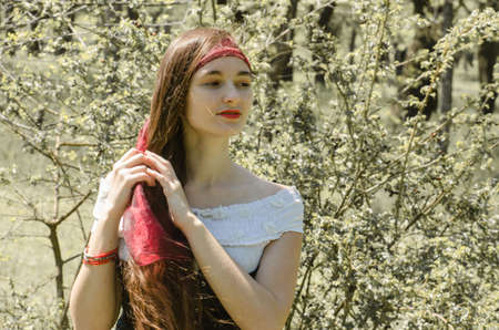 Beautiful young girl with long hair in a 15th century costume.