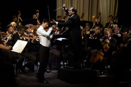 DNEPROPETROVSK, UKRAINE-OCTOBER 31: Violinist Daniel Milkis and Moscow State Academic Symphony Orchestra - main conductor Pavel Kogan performed music of Beethoven on October 31,2011 in Dnepropetrovsk, Ukraineのeditorial素材