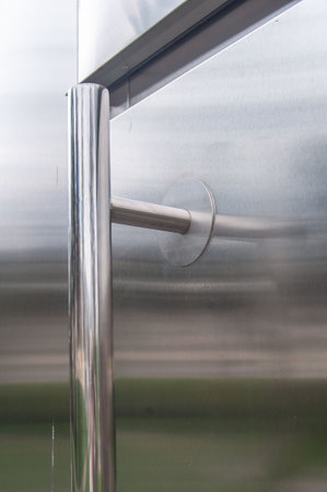 Fragment of a closed metal door outdoors.の写真素材