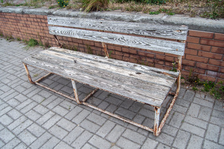 An old bench in a public place, in the courtyard of the house.の写真素材