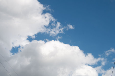 White Cloud on a blue sky on a sunny day over the cityの写真素材