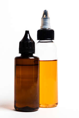 e- liquid, e-juice in the bottles isolated on the white background with copyspace