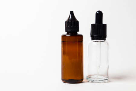e- liquid, e-juice in the bottles isolated on the white background with copyspaceの写真素材