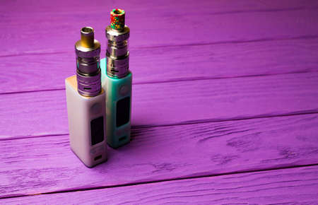 two e-cigarette (electronic cigarette, vape) on the wood background 