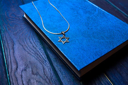 David star jewish symbol on a wooden background with bookの写真素材