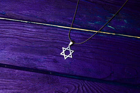 David star jewish symbol on a wooden background with bookの写真素材