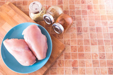 top view of process of cooking chicken breast in the kitchen with meat tenderizer hammer and knife の写真素材