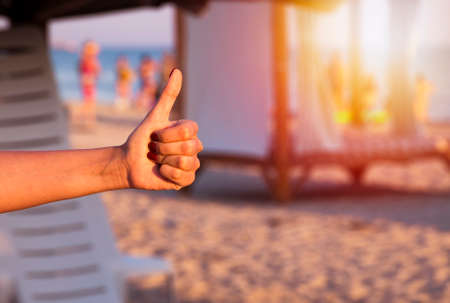 girl showing her liking to sea, beach, travell or something else with her thumb down の写真素材
