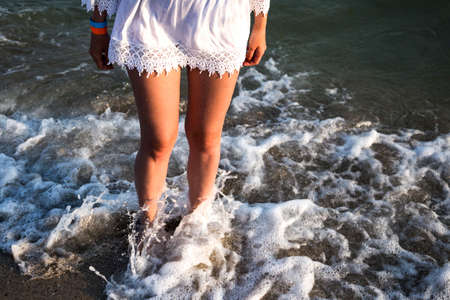 Girl with beautiful legs relax near the sea 