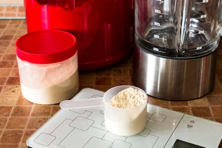 sport nutrition, supplements: protein, pre-workout complex, bcaa, scale in the kitchen の写真素材