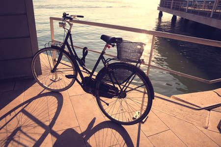 bicycle with basket on the coast on the sunset の写真素材