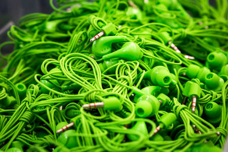 box with lots of green headphones 