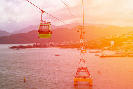 Modern cabins of the world's longest cable car (cableway) with a beautiful view of the sea and mountainsの写真素材