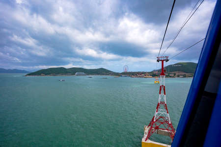 view from cabins of the world's longest cable car (cableway) with a beautiful view of the sea and mountainsの写真素材