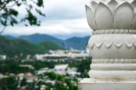 decorations of the Buddhist pagoda with mountains and city on the background の写真素材