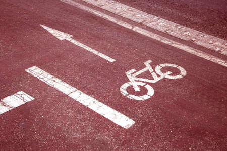 bike path (bicycle lane) sign on the road of the city (red toned, concept of dangerous)の写真素材