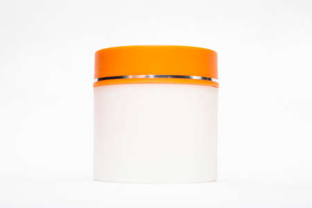 blank mock up advertising with copy space of the white jar with orange cap isolated on the white backgroundの写真素材