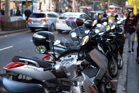 Scooters parked on the one of the main streets in the Barcelona, Catalonia, Spain. 2019-05-01.のeditorial素材