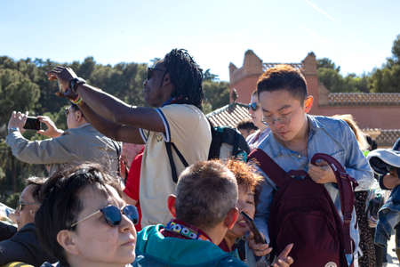 Multinational group of tourists from different countries in the Park Guell, Barcelona, Catalonia, Spain 2019-05-01のeditorial素材