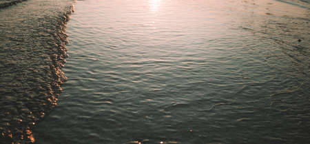 Panoramic widescreen view on the deep blue sea or ocean with dramatic toning on sunset or sunrise. ...