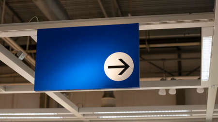 Mock up of sign with arrow and blue background. Direction or way concept. Copy space for text, logo.