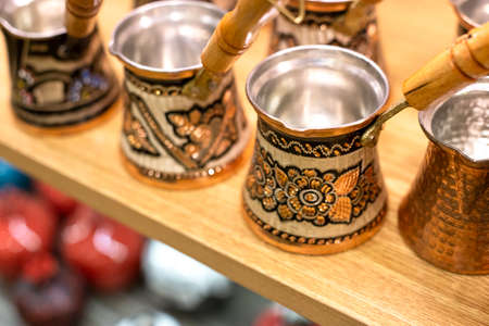 Traditional Turkish cezve - copper coffee pots on the shelf in the shop. One of the most popular souvenir from Istanbul, Turkey. 2019-08-11のeditorial素材