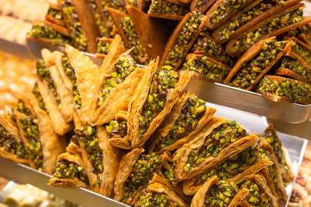 Traditional delicious turkish dessert baklava in the shop window showcase. Different kinds of...