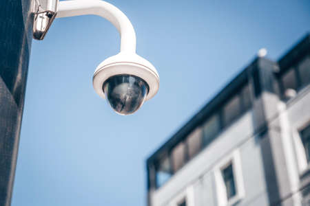 Modern surveillance cameras on the street. Cctv equipment. Blue sky on the background. Protection...