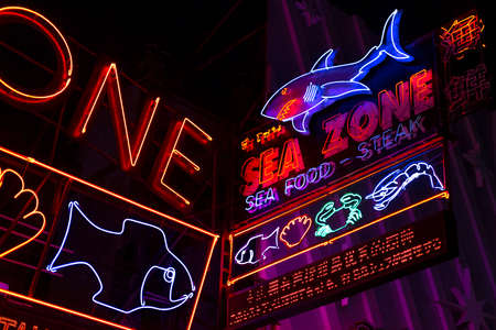 Neon billboards on the famous Walking Street in Pattaya, Thailand 2019-12-23.