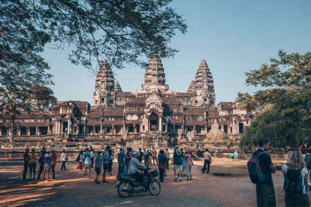 Angkor Wat - Hindu temple complex in Cambodia, largest religious monument in the world. Popular tourist attraction. View on the towers through the forest. Cambodia, Siem Reap, 2019-12-28のeditorial素材