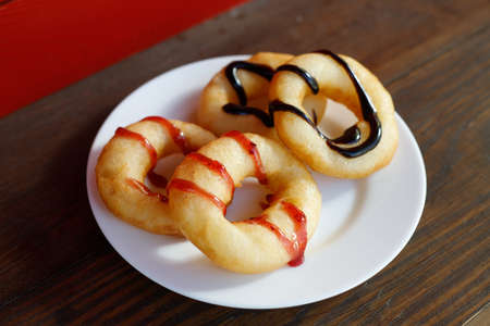 Fresh donuts with jam in the bakery for celebration