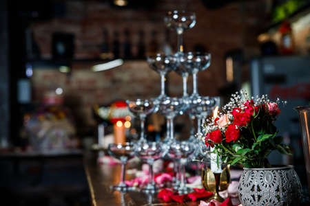 Closeup Table setting, adorned with flowers. Floral decoration for romance dining. Wedding banquet , festive decor. Concept of service and catering.の写真素材