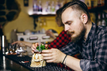 KHARKIV, UKRAINE â MAY 26, 2019: Brutolny bartender man does pouring whiskeyのeditorial素材