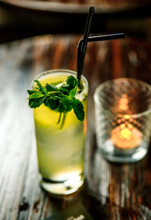 Fresh Mojito cocktail with lime, rosemary, mint and ice in jar glass on. Summer cold drink and cocktailの写真素材