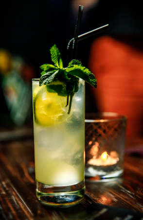 Fresh Mojito cocktail with lime, rosemary, mint and ice in jar glass on. Summer cold drink and cocktailの写真素材