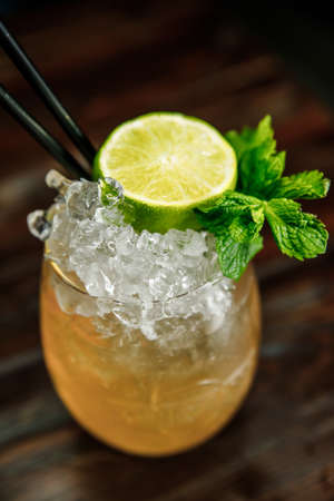 Fresh Mojito cocktail with lime, rosemary, mint and ice in jar glass on. Summer cold drink and cocktailの写真素材