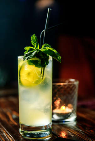 Fresh Mojito cocktail with lime, rosemary, mint and ice in jar glass on. Summer cold drink and cocktailの写真素材