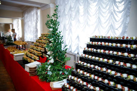 A varied buffet on a long red table.の写真素材