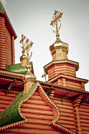 Dome with a cross of a wooden Christian church in the sun. View from below.の写真素材
